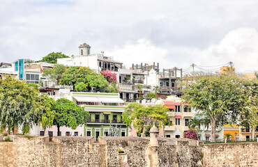 San Juan, Puerto Rico - March 26, 2024: View from the water of the fortified walls and old town of...