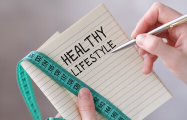 Healthy Lifestyle handwriting on notebook in hands, Concept Active lifestyle.