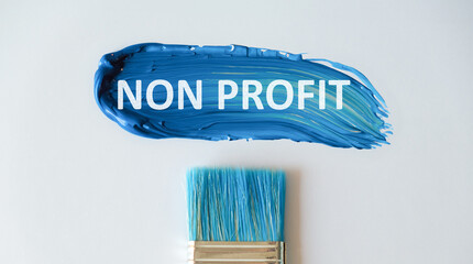 On a bright blue background, a strip of smeared paint and white paper with the text Non Profit.