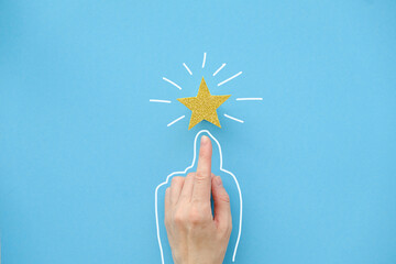 The finger of the hand points to a shiny star on a blue background. Best Customer Experience...