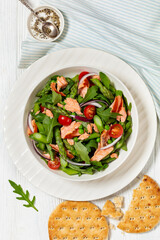 smoked salmon salad with spring veggies in bowl