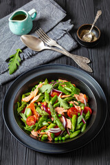 smoked salmon salad with spring veggies in bowl