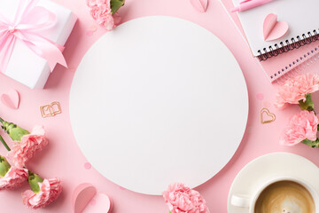 Mother's day creative workspace: top view of carnations and gift with blank round space on pink...