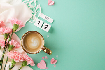 Mother's day relaxed planning: top view of coffee, carnations, and may calendar on a turquoise...