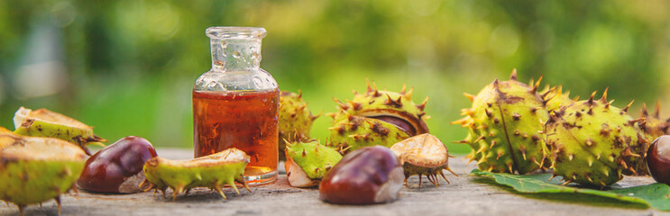 Horse chestnut extract in a bottle. selective focus. - obrazy, fototapety, plakaty