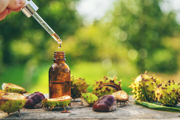 Horse chestnut extract in a bottle. selective focus. - obrazy, fototapety, plakaty