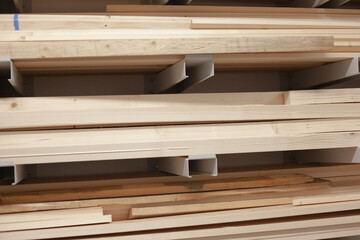 Stacked wood boards for machinery. Pine board beams stacked and organized at warehouse.