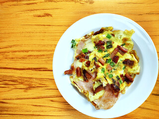 Top view of complete Omelette with bacon, ham, chesse on the wooden background
