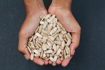 Holding some Round bottle gourd fruit seeds with hand 