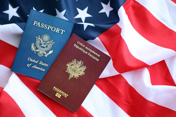 Passport of France with US Passport on United States of America folded flag close up
