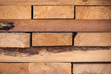 Naklejka premium Wooden planks stacked together as a wall background texture closeup.