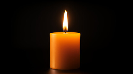 one small pillar candle orange colored candle  burning on black background
