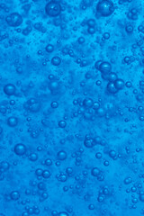 Bubbles in the water on a blue background. Closeup.