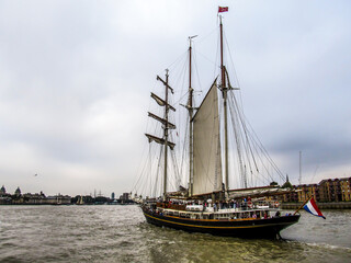 A relatively small Two-masted sailing vessel on the River Thames at Greenwich in the Greater London, UK, during the Tall ship festival © Marieke