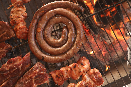 meat on the grill. South African braai meat including Boerewors, chicken kebabs and lamb chops 