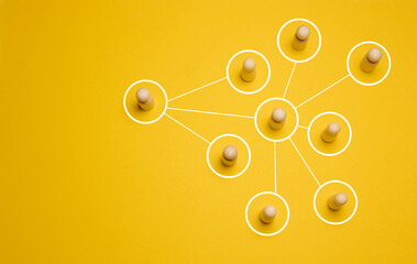 Wooden figures connected by lines, concept of delegation and hierarchy in a company