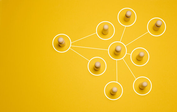 Wooden figures connected by lines, concept of delegation and hierarchy in a company