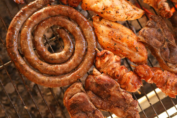 meat on the grill. South African braai meat including Boerewors, chicken kebabs and lamb chops 