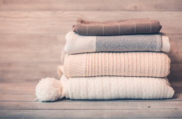 Stack of cozy knitwear in winter time