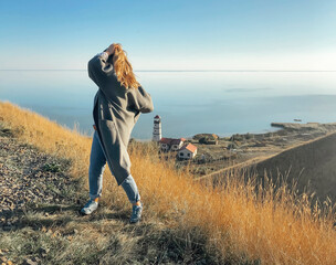 Carefree woman on hill against sea