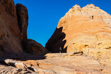 Female Hiker on Aztec Sandstone Formations Near The Upper Fire Canyon Wash, Valley of Fire State Park, Nevada, USA