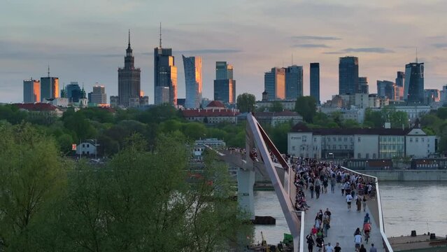 Warszawa, Poland - April 9, 2024: The panoramic view of downtown Warsaw boasts a vibrant mix of monuments and modern skyscrapers, framed by the shape of the newly opened pedestrian and bicycle bridge