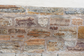 old  brick wall with colorful stones