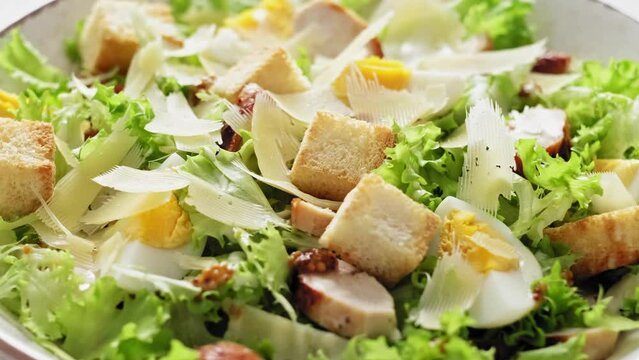 Caesar salad with lettuce, croutons, eggs, and grilled chicken breast, stock footage video 4k
