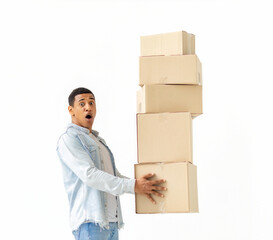 Young excited African American man with stack of cardboard boxes on white background. Moving concept