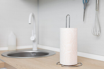 The kitchen towel holder stands on the kitchen countertop.