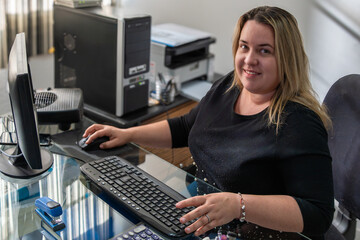 Confident Woman Working with Computer in Office