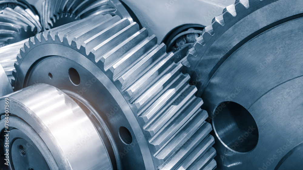 Poster A close up of a set of gears with the idea of the gears working together to create movement