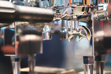 A coffee machine with a silver handle and a silver spout