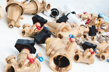 A collection of brass valves and fittings. The valves are of various sizes and colors, including...
