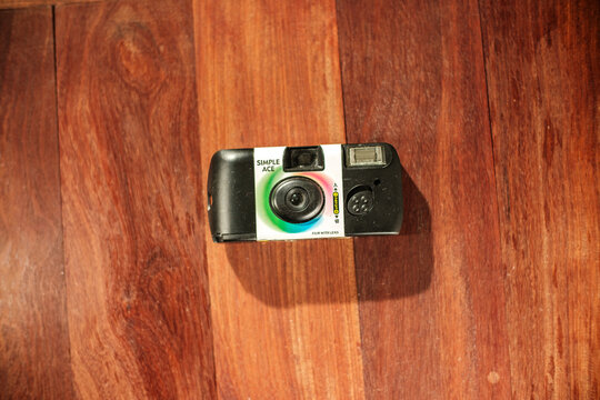Top down shot of Fujifilm Simple Ace disposable camera on floor