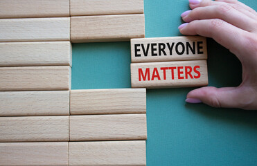 Everyone matters symbol. Concept words Everyone matters on wooden blocks. Beautiful grey green background. Businessman hand. Business and Everyone matters concept. Copy space.