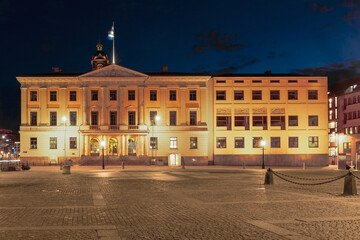 The Gothenburg City Hall illuminated at night, showcasing neoclassical architecture and a welcoming glow, concept of governance and history. Gothenburg, Sweden