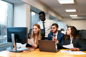 Multiethnic business group in suit and tie at office. African, Arabic, Caucasian men and woman...