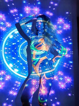 Artistic image of a woman in detailed body paint against a vibrant retro backdrop, blending traditional art with contemporary elements for a captivating composition.