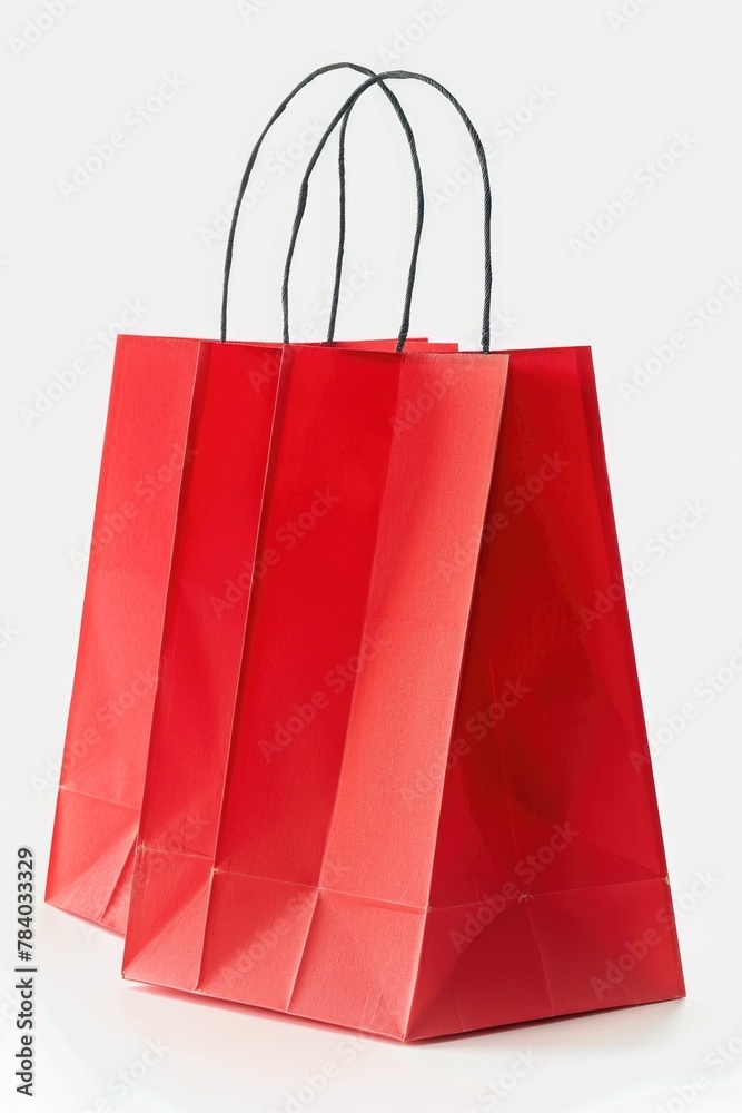 Poster A simple red paper shopping bag on a white surface. Suitable for various shopping or retail concepts