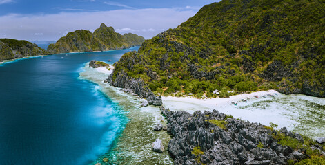 Aerial panoramic view of karst sharp cliffs of limestone island on adventures tour of El Nido,...