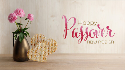 Peonies flowers in the vase and matzah in the form of a heart. Passover Jewish holiday concept.
