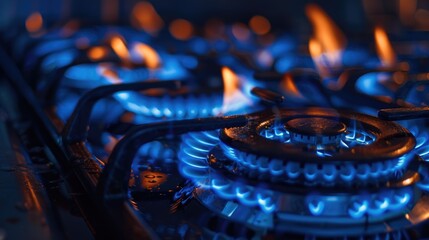 Close up of a gas stove with blue flames, suitable for kitchen appliance concepts - obrazy, fototapety, plakaty