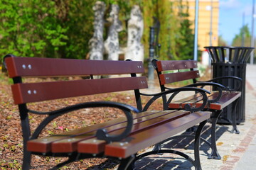 Brown benches on the sidewalk