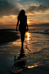 A woman enjoying a peaceful walk on the beach at sunset. Perfect for travel and relaxation concepts