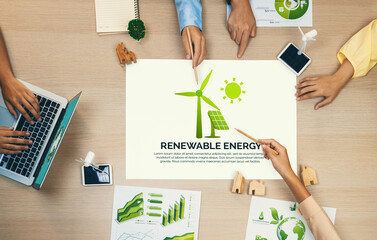 Renewable energy illustration placed on a meeting table during a green business meeting discussion....
