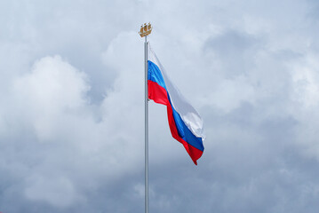 The Russian flag flutters in the wind against the blue sky, Background.