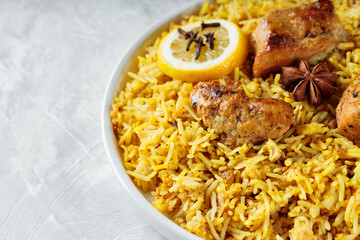 Plate of Traditional Chicken Biryani on gray background, Indian Cuisine Concept