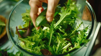 Fotobehang Person blending fresh lettuce in a kitchen blender. Great for healthy eating concepts © Fotograf