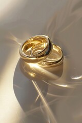 Two gold wedding rings on a reflective surface. Ideal for wedding and jewelry concepts